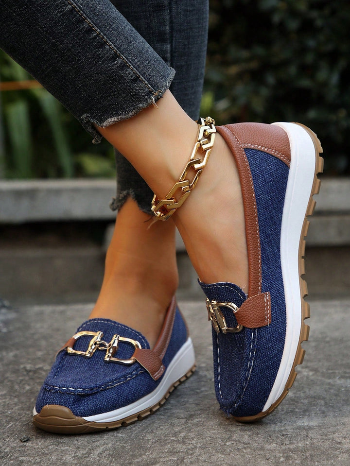 Comfortable women's flat loafers with chic buckle detail. Easy slip-on style for versatile everyday wear.