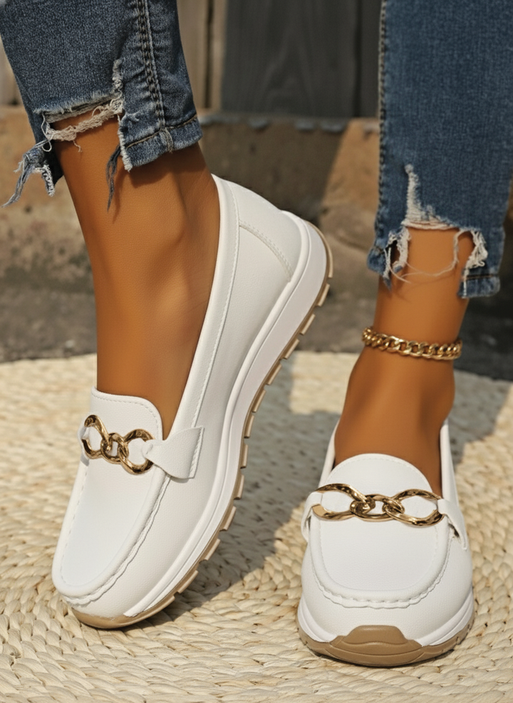 Classic women's flat loafers with a stylish buckle, offering comfort & elegance for daily outfits.