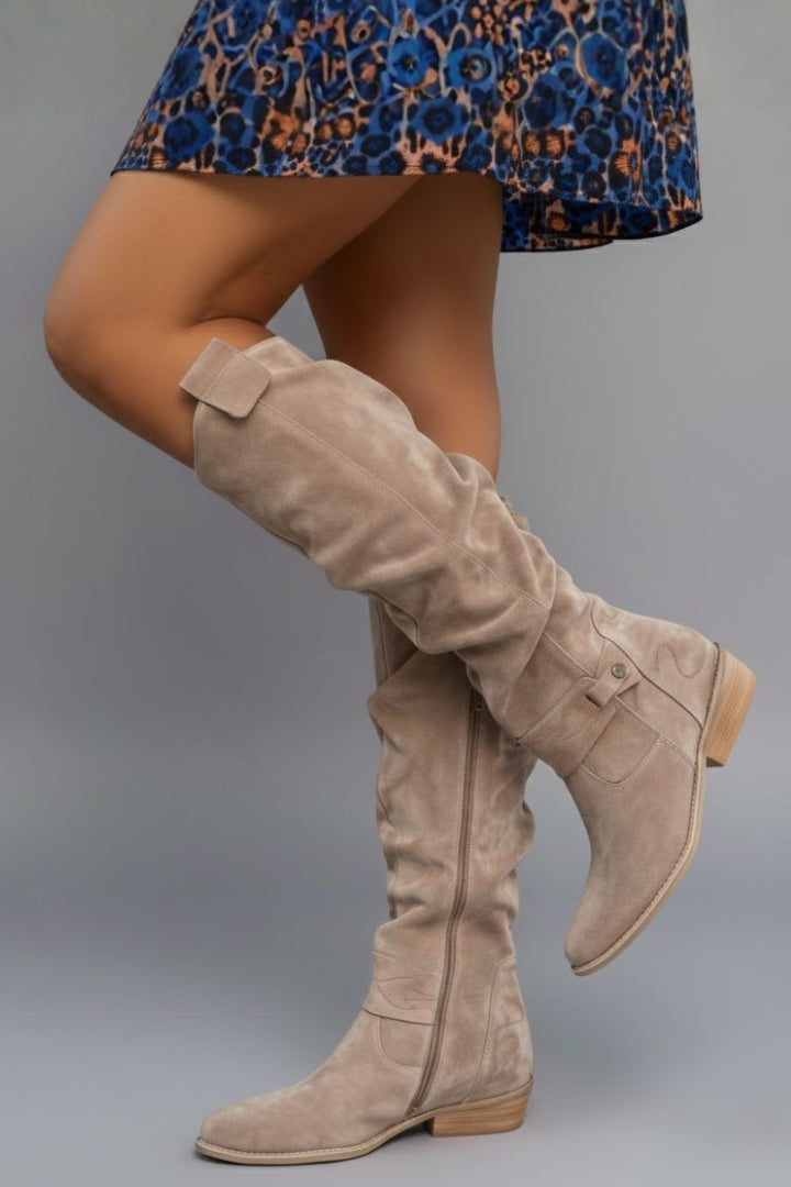 Black women's flat knee-high boots. Stylish & comfortable winter footwear for everyday elegance.