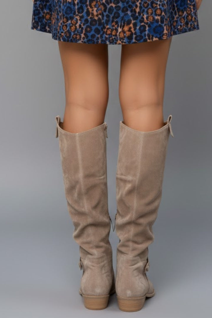 Side view of women's flat heel knee-high boots, emphasizing comfort and sleek design.