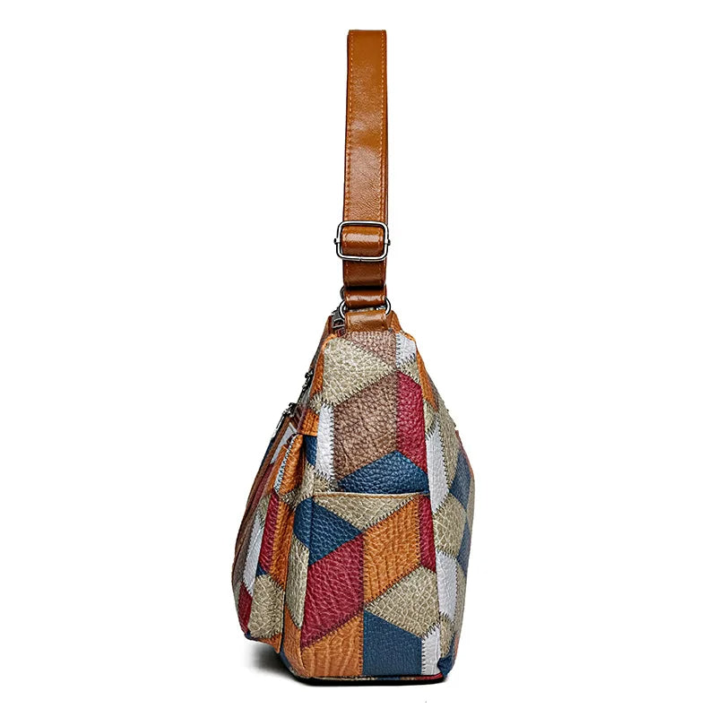 Front view of a women's stylish geometric patchwork vegan leather handbag, perfect for an organized look.