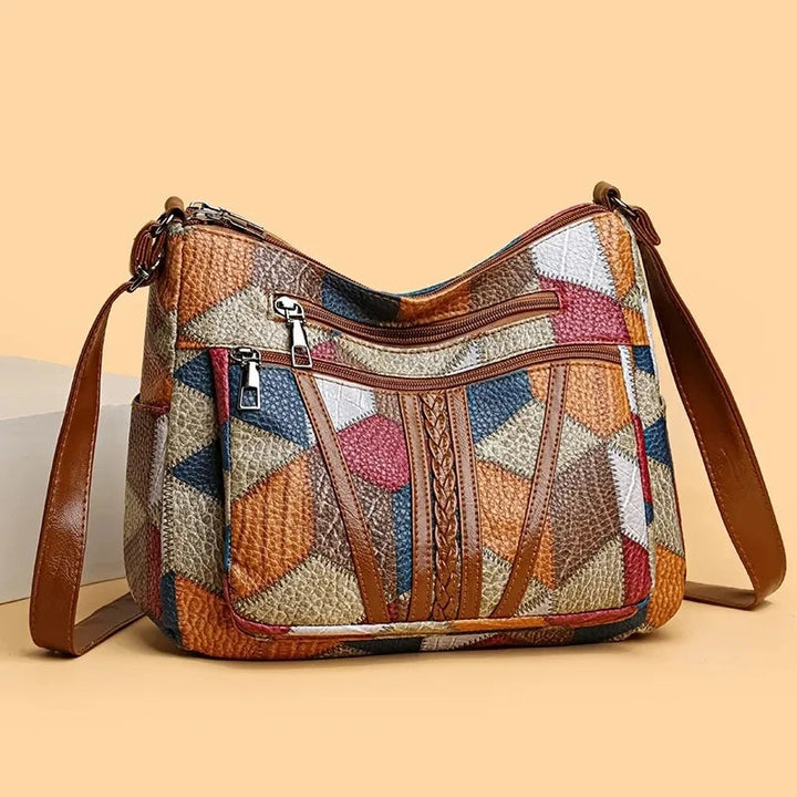 Elegant vegan leather crossbody bag for women, featuring a unique geometric patchwork and durable finish.