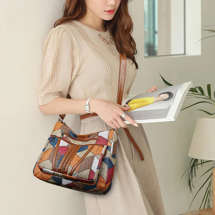 Stylish women's geometric patchwork crossbody bag with adjustable strap, crafted from high-quality vegan leather.