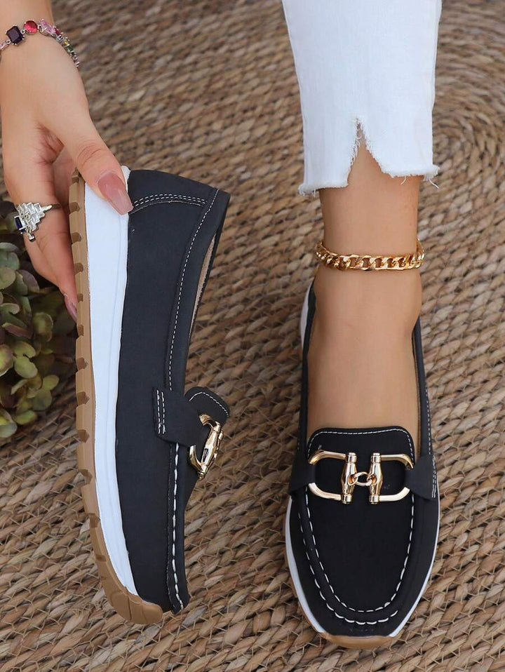 Women's flatform loafers with comfortable round toe & gold chain detail. Stylish slip-on footwear for women.
