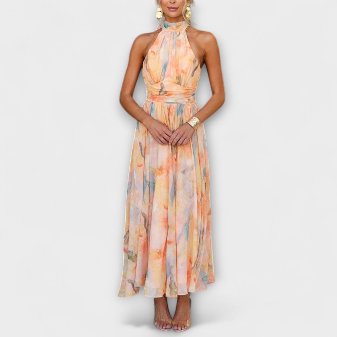 Women's stylish halter maxi dress with watercolor print, flowy fabric, perfect for summer elegance or beach wear.