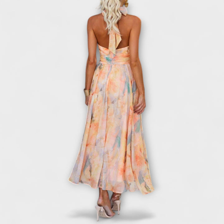 Elegant women's halter maxi dress, open back detail, vibrant watercolor print, ideal for parties and summer occasions.