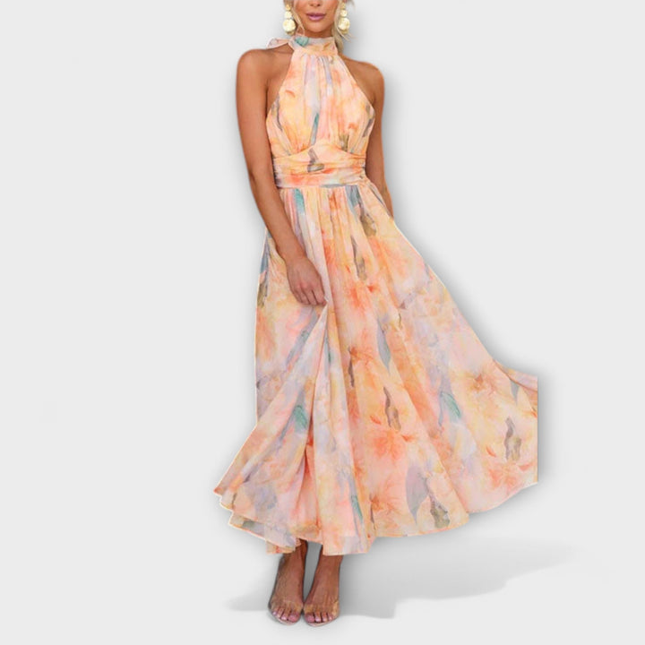 Flowy halter maxi dress for women, featuring a beautiful watercolor print, a chic choice for summer parties or elegant events.