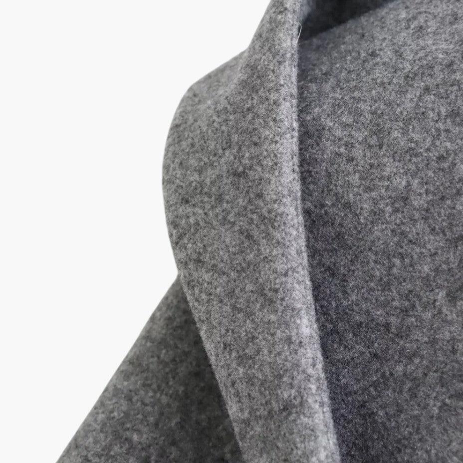 Women's hooded trench coat with button front & belt, a classic piece of women's outerwear for fall/spring.