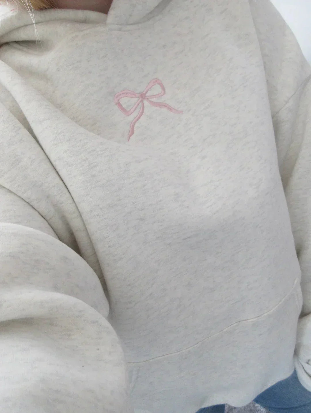 Women's stylish hoodie with an elegant bow detail, perfect for comfortable casual wear. Cozy pullover for fall fashion.