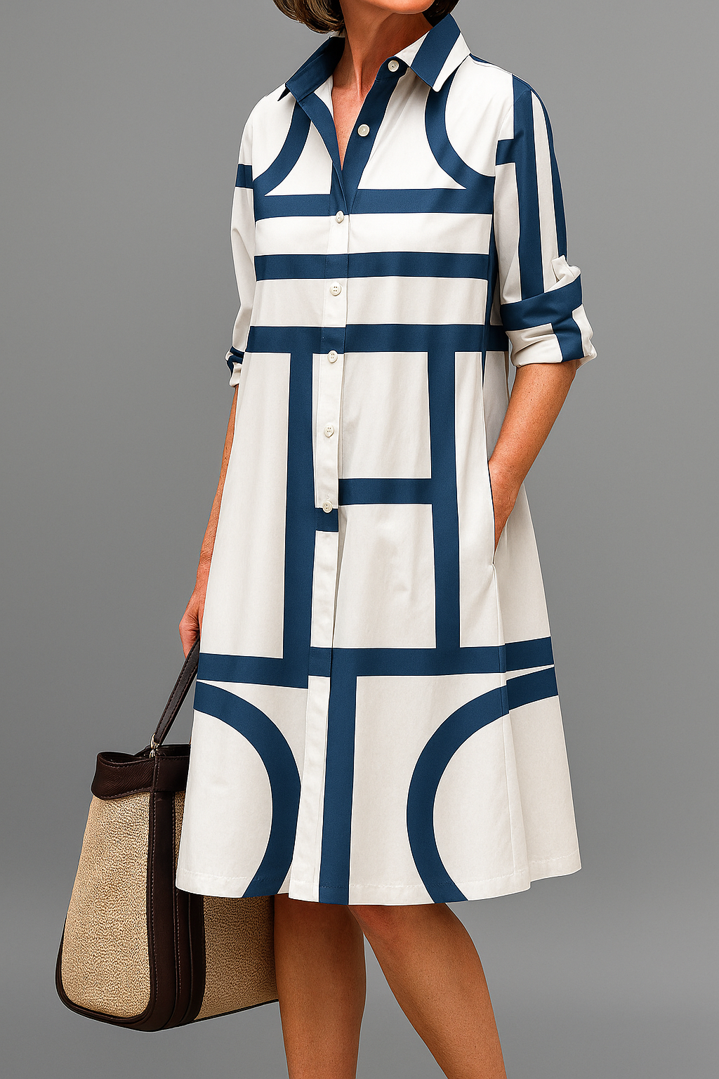 Women's stylish white shirt dress with geometric print, collared, button-up, knee-length, relaxed fit for casual wear.