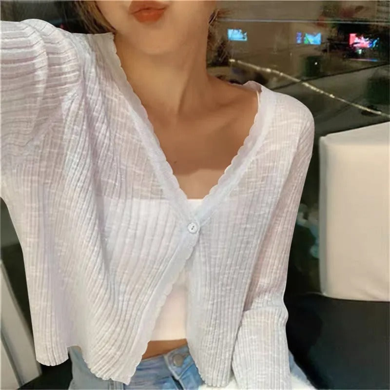 Stylish women's summer cropped cardigan. Versatile button-front, long-sleeve top for elegant casual layering.