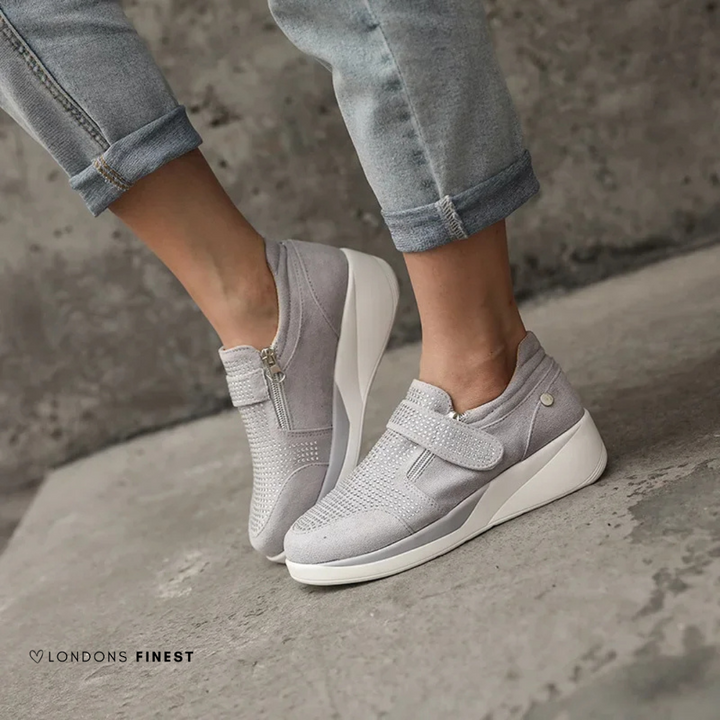 Lightweight women's comfort sneakers, ergonomically designed with cushioned arch support for all-day wear.