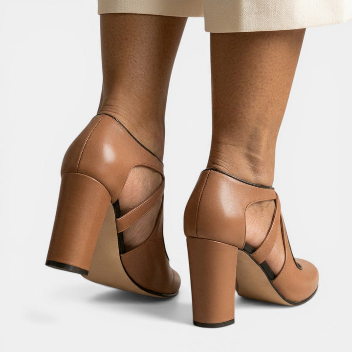 Classic women's T-Strap high heels with a comfortable round toe and adjustable buckle closure. Versatile footwear.