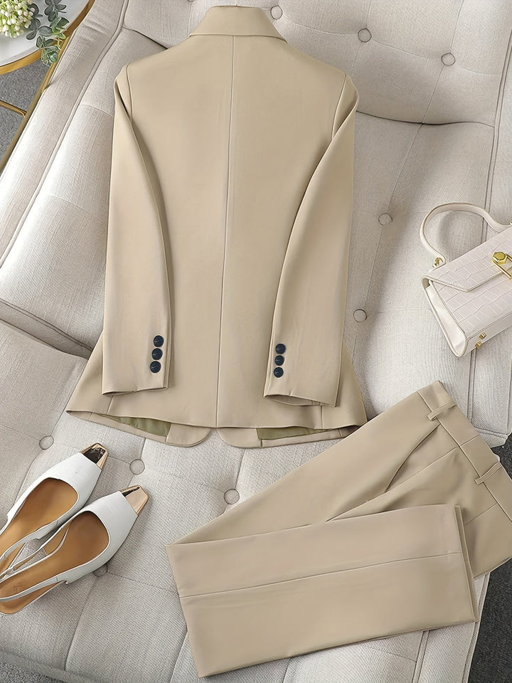 Modern women's matching blazer and slim trousers set. Elegant notched lapel design for chic professional attire.