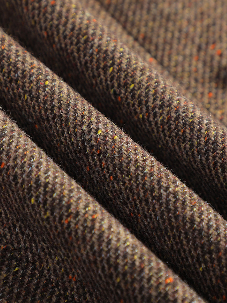 Close-up of a women's tailored pink cotton blazer showing fabric texture and single-button detail