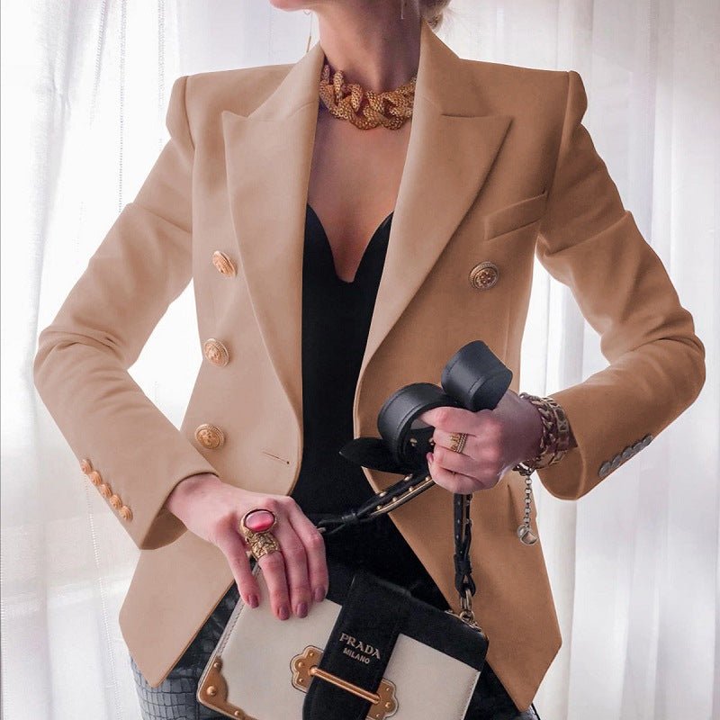 Detailed shot of gold buttons on a women's tailored double-breasted blazer. Elegant professional jacket.