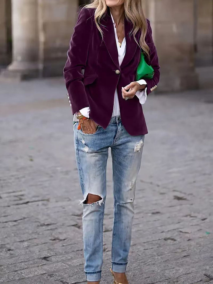 Stylish women's tailored velvet blazer, a chic outerwear option with elegant gold buttons.