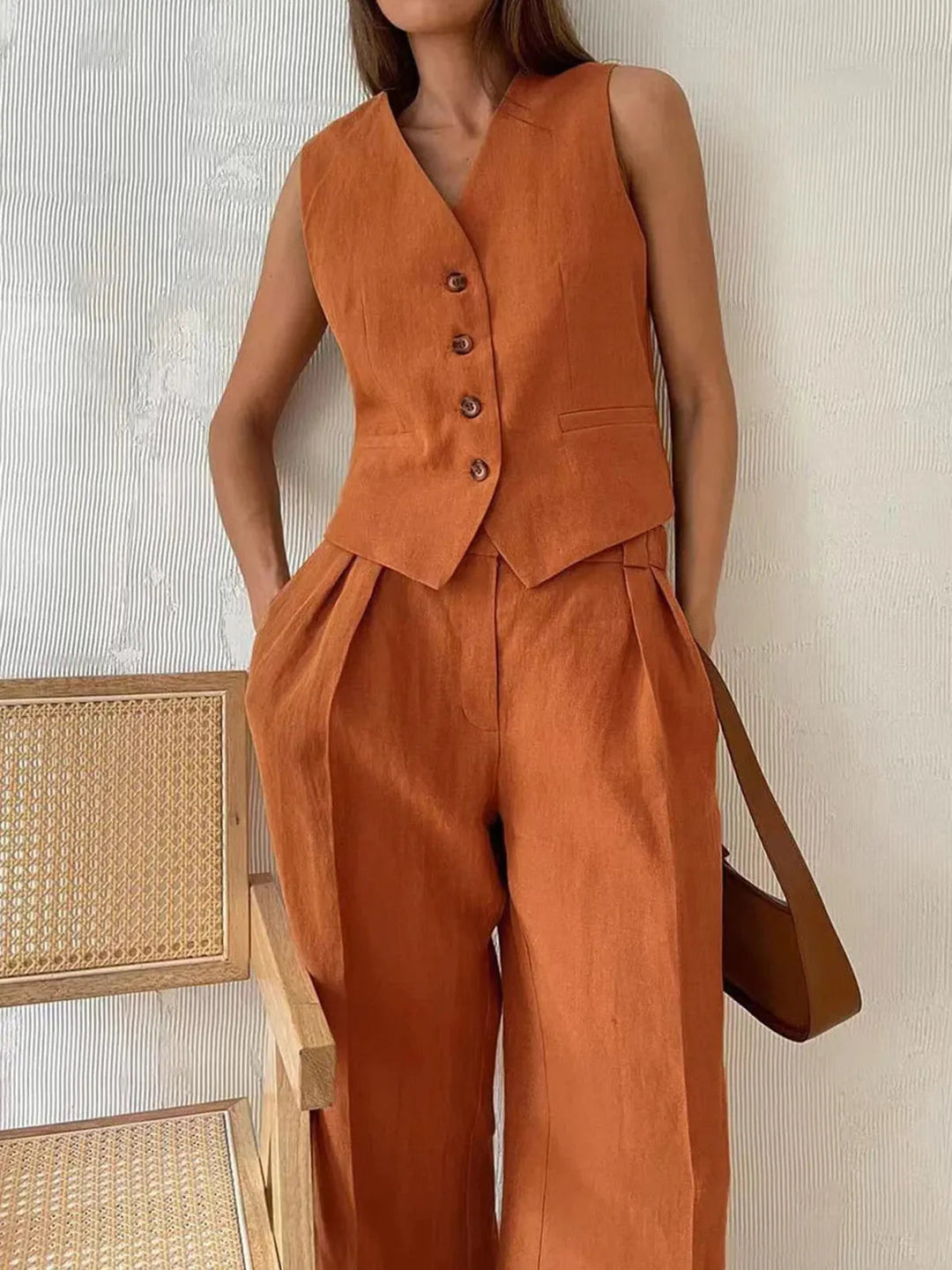 Stylish women's matching two-piece set: tailored waistcoat & wide leg trousers. Chic for summer office wear.