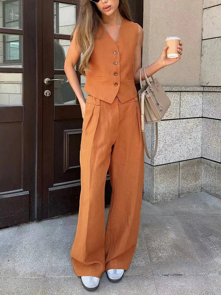 Women's chic tailored waistcoat with wide leg trousers. A sophisticated pant set for elegant summer outfits.