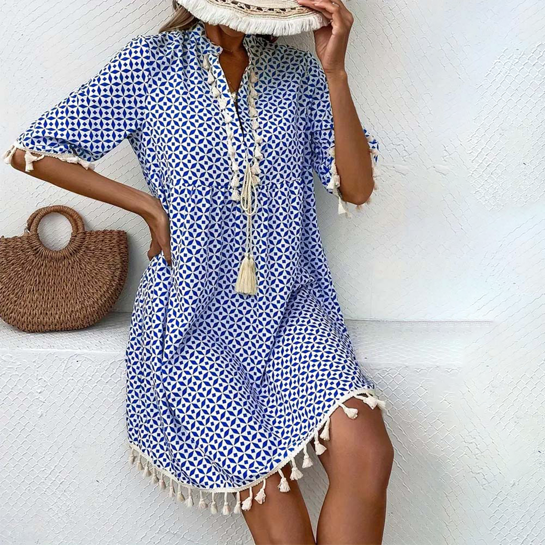 Women's tassel trim mini dress, short sleeve, vibrant print. Effortless summer casual wear or beachwear.