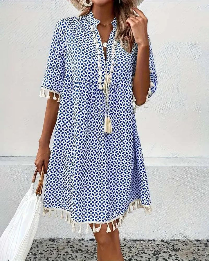 Boho chic printed mini dress for women with V-neck and tassel trim. Ideal for summer days & beach.