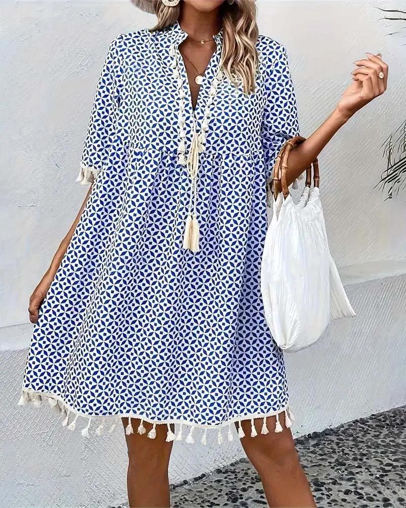 Printed V-neck women's mini dress with stylish tassel trim & short sleeves. Perfect for spring/summer fashion.