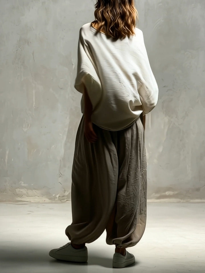 Taupe wide leg harem pants for women, featuring a high waist & drawstring. Perfect for comfortable travel & relaxed fits.
