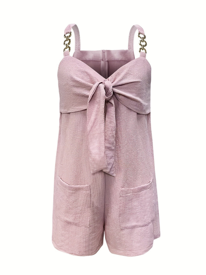 Model wearing a women's textured short romper with sweetheart neck and fashionable chain straps.