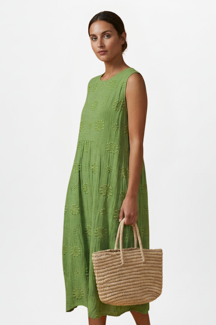 Full length view of women's textured sleeveless midi dress with pockets, round neck, summer-ready.
