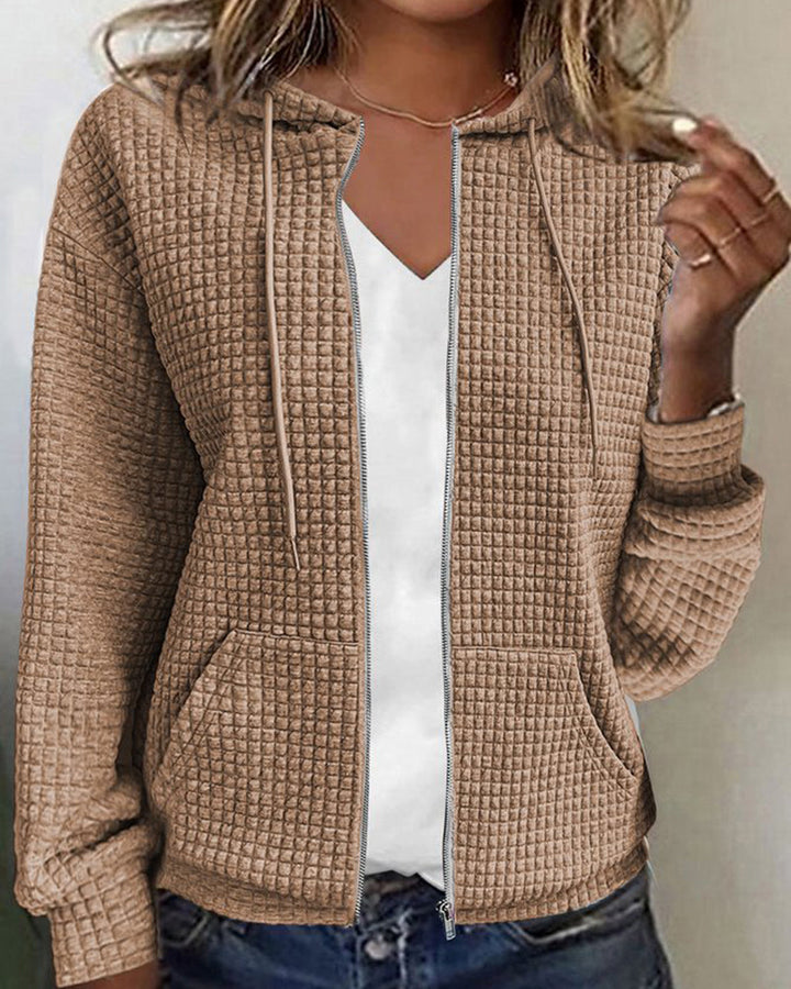 Comfortable women's textured zip-up hoodie jacket. Cozy hooded design with convenient front pockets for women's fashion.