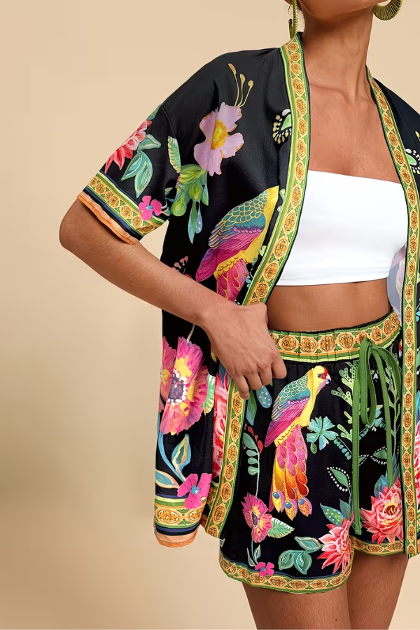 Fashionable women's tropical print summer two-piece set. Chic shorts outfit for beach & resort style.