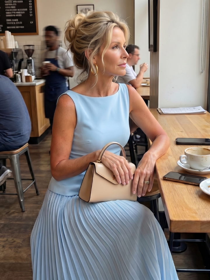 Women's elegant structured sleeveless top & pleated maxi skirt two-piece set. Ideal for party wear.