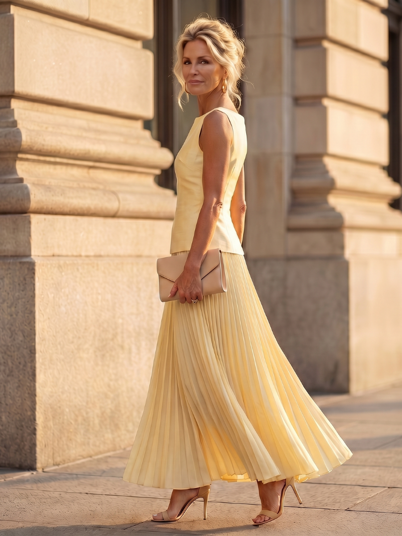 Sleeveless structured bodice and flowy pleated maxi skirt two-piece set for women. Summer elegant outfit.