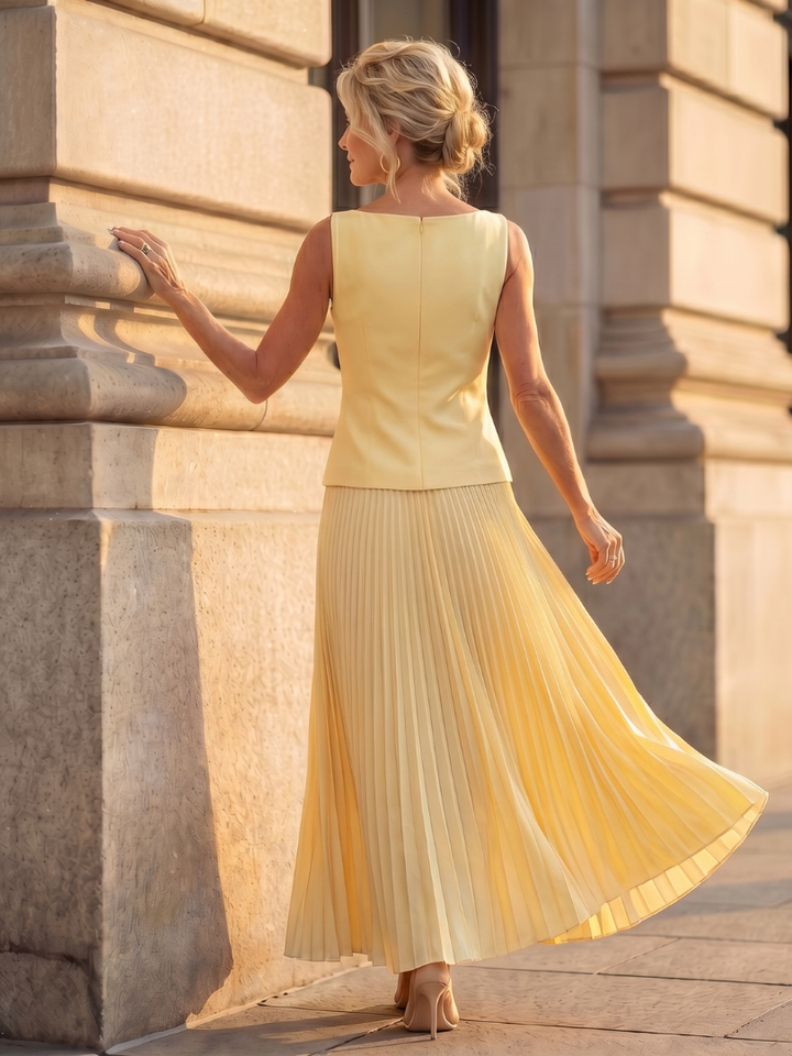 Elegant women's two-piece set featuring a structured bodice & pleated maxi skirt. Ideal for summer parties.