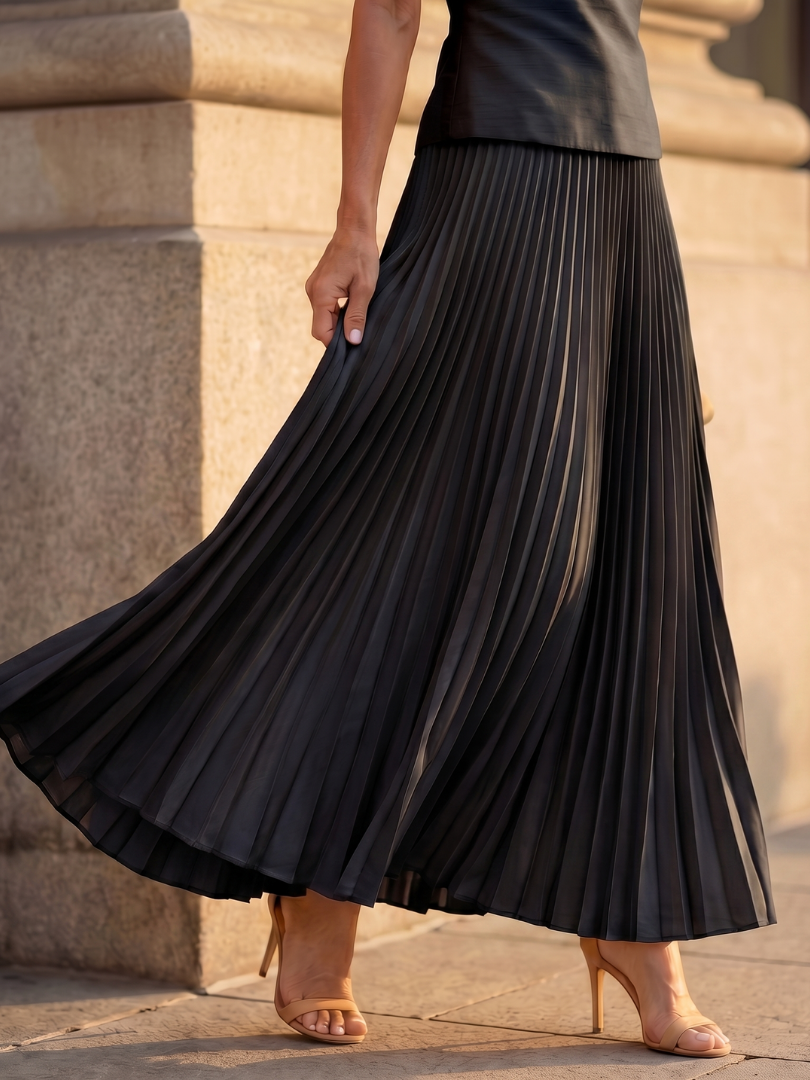 Structured bodice and flowing pleated maxi skirt two-piece set for women. Elegant party fashion outfit.