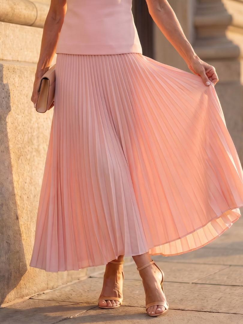 Stylish women's two-piece set: structured sleeveless top & flowing pleated maxi skirt. Elegant occasions.