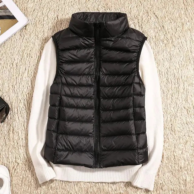 Women's ultra-light down vest, warm & packable. Essential lightweight outerwear for layering in fall & winter.