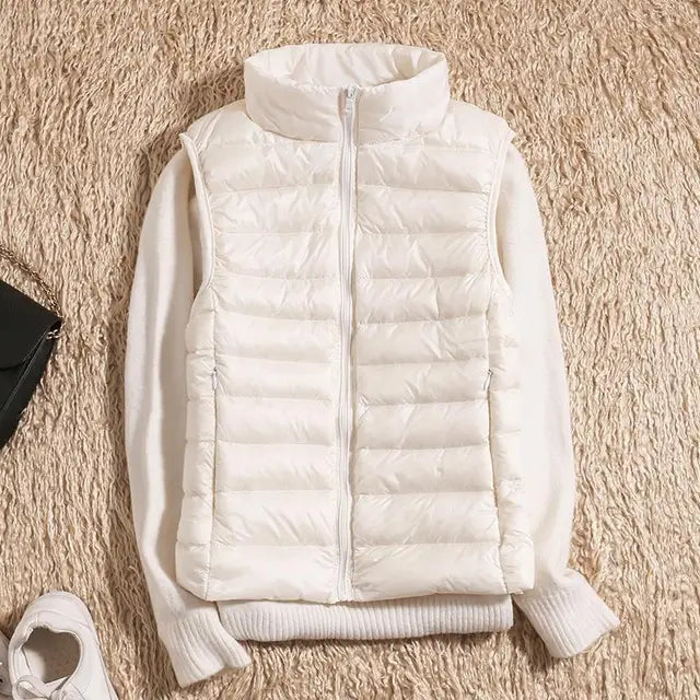 Women's packable travel vest, ultra-light down insulation for easy carrying. A warm sleeveless jacket for trips.