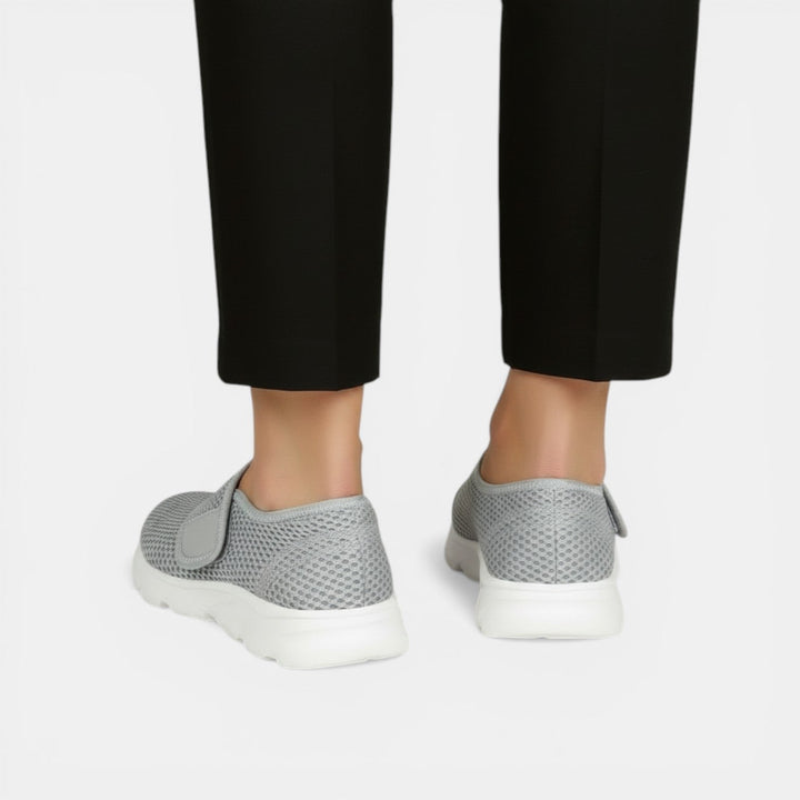 Lightweight women's athletic sneakers, ideal for walking, offering comfort and support with a slip-on style.
