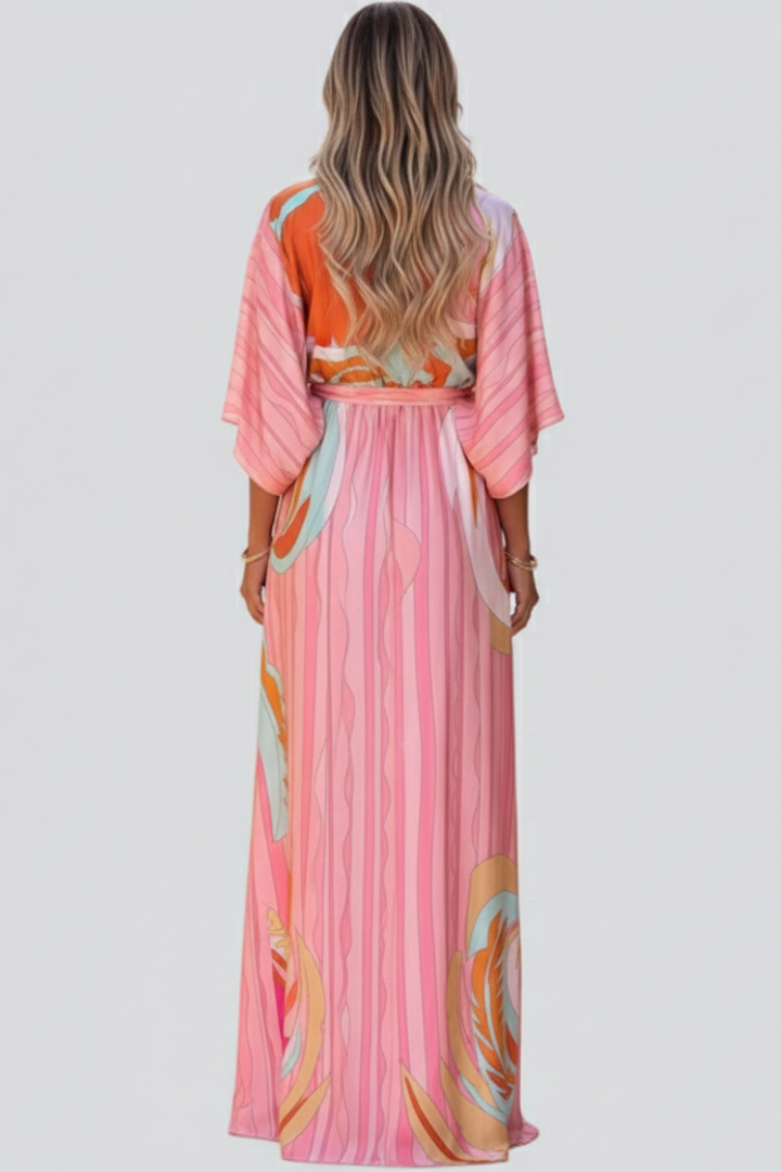Abstract print women's maxi dress with a V-neckline and matching belt, a flowing and elegant choice for spring fashion.