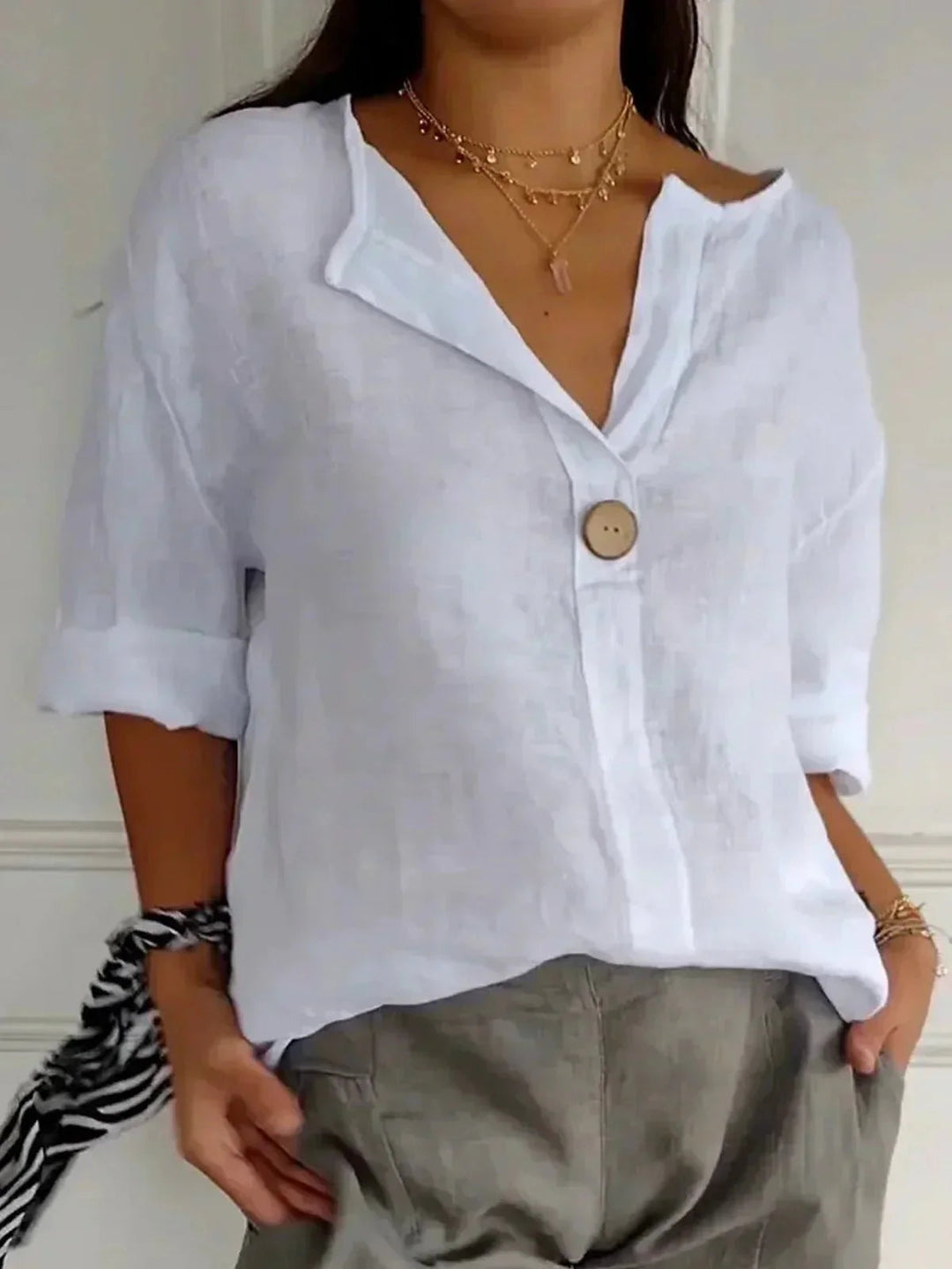 Relaxed fit women's V-neck blouse with roll-tab sleeves, a versatile casual top for work or everyday style.