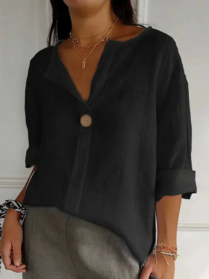 Button-down V-neck women's blouse with functional roll-tab sleeves, ideal for comfortable office wear.