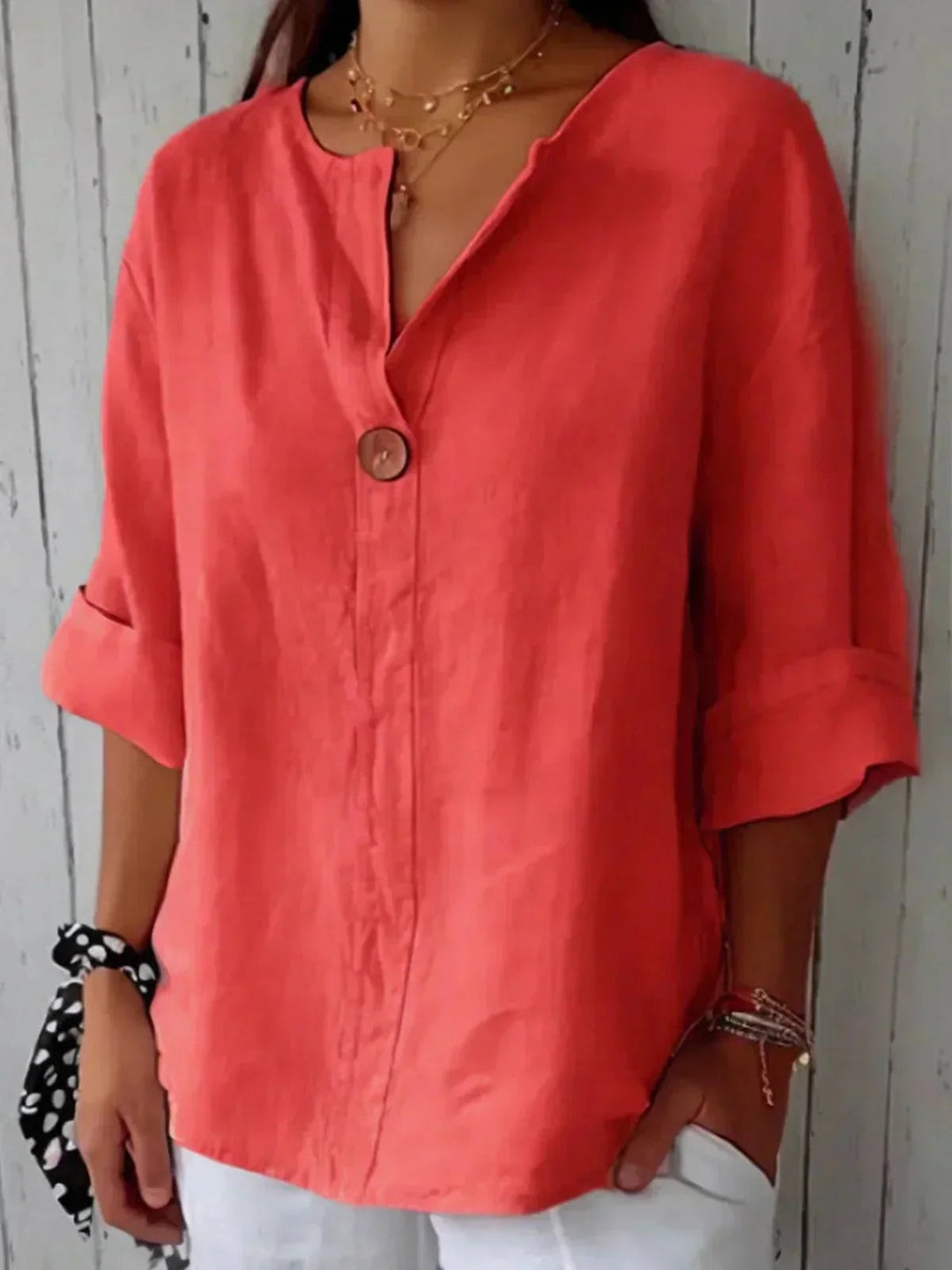 Stylish V-neck women's blouse featuring roll-tab sleeves & relaxed fit, a classic summer fashion top.