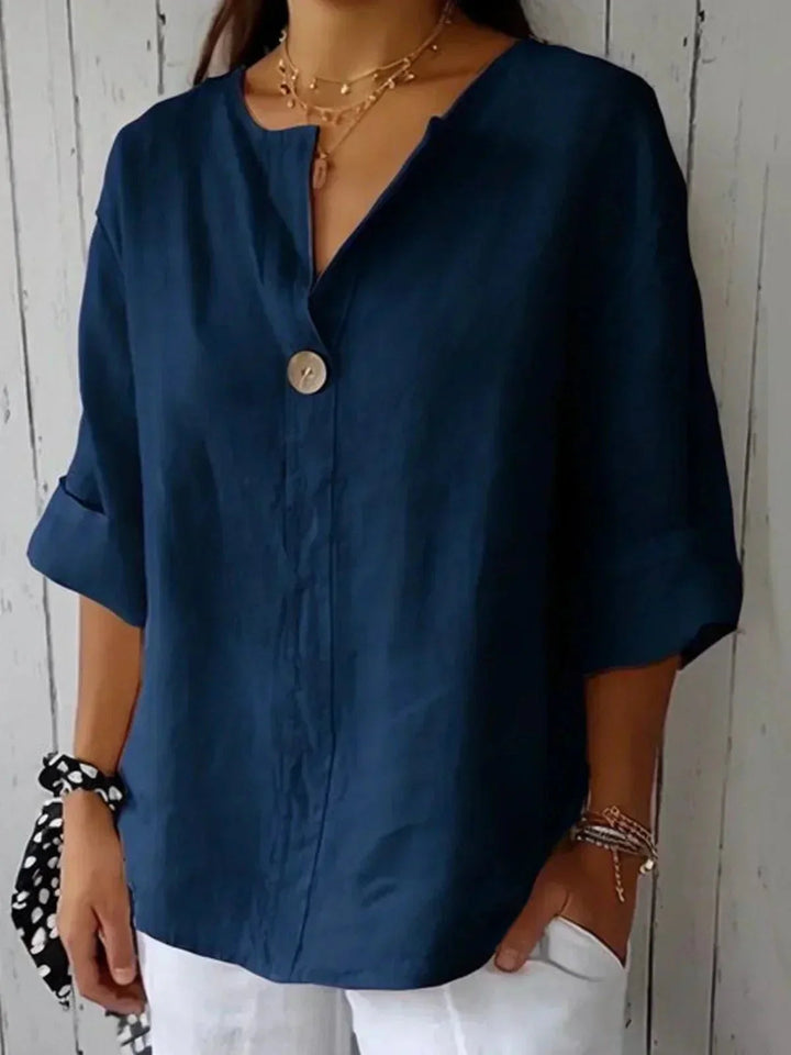 Elegant V-neck women's blouse, button-down with adjustable roll-tab sleeves, perfect for spring/summer comfort.