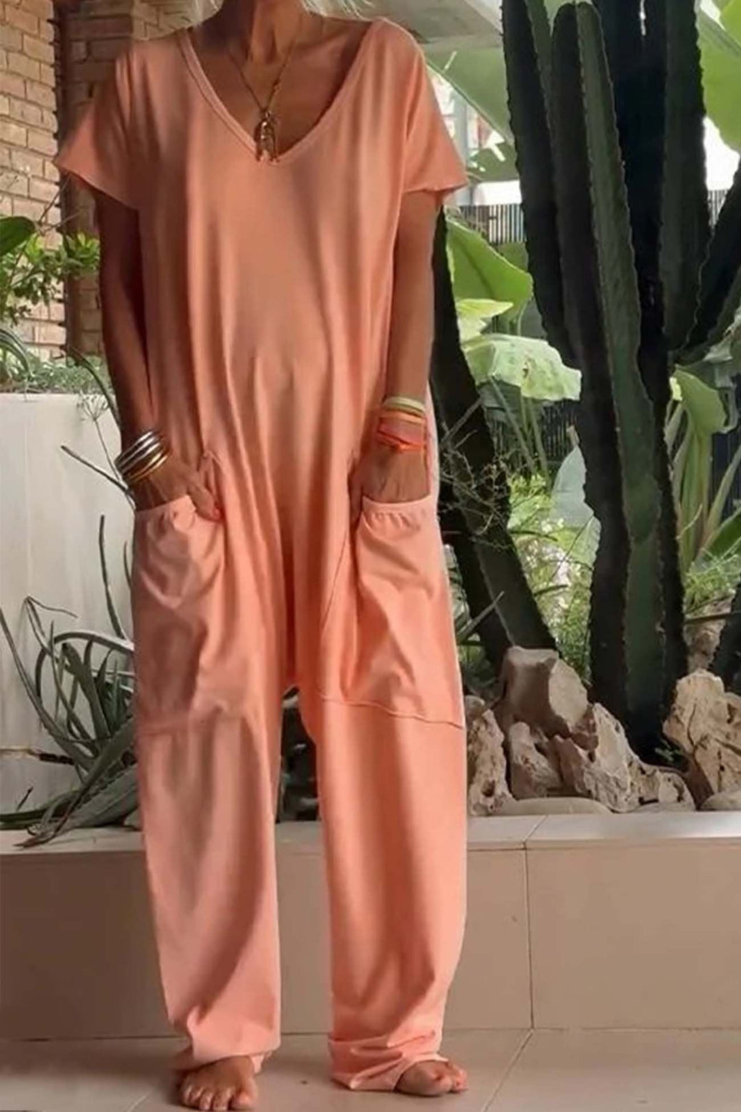 Easy wear women's V-neck short sleeve jumpsuit. Relaxed fit with functional oversized pockets.