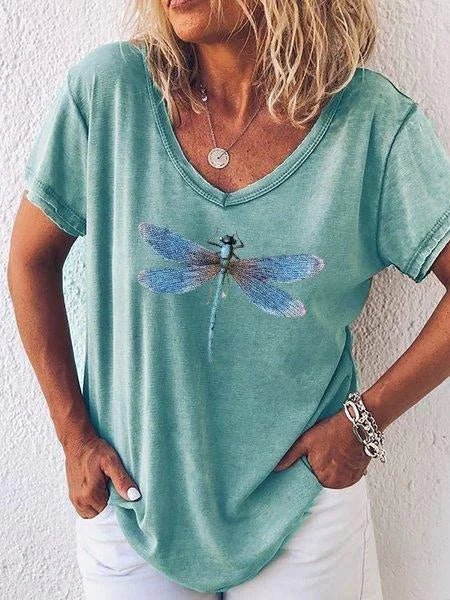Women's casual V-neck top with intricate dragonfly graphic and trendy cuffed short sleeves. Relaxed fit for ladies.