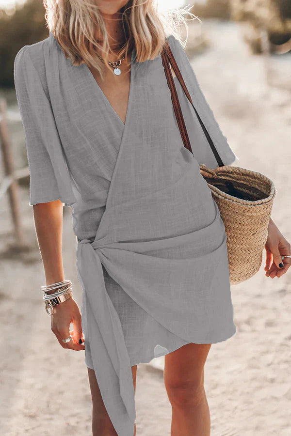 Women's V-neck draped mini dress, vibrant & chic for summer parties, vacations & elegant fashion.