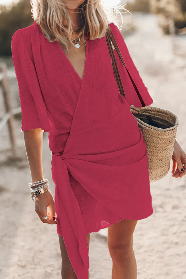 Elegant women's V-neck mini wrap dress, flattering draped style perfect for casual outings or party wear.