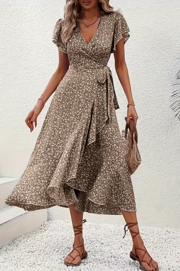 Chic women's floral dress, V-neck, asymmetrical design for elegant occasion wear.