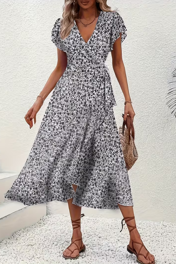 Women's V-neck midi floral dress with an asymmetrical hem, sophisticated and stylish.